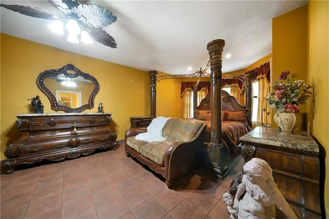 a bedroom with a bed and ceiling fan