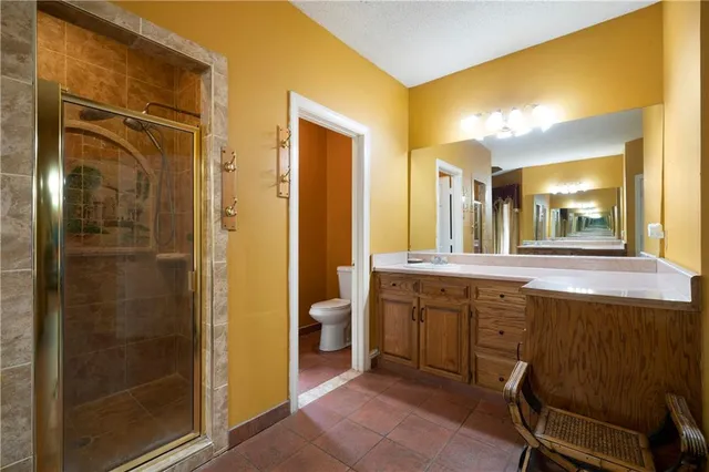 a spacious bathroom with a mirror sink and a shower