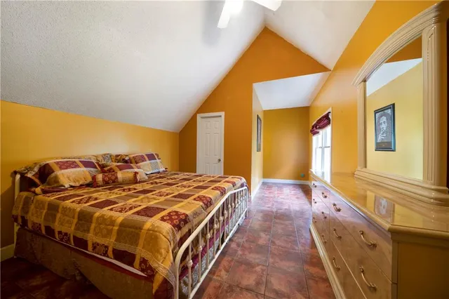 a bedroom with a bed and a large window