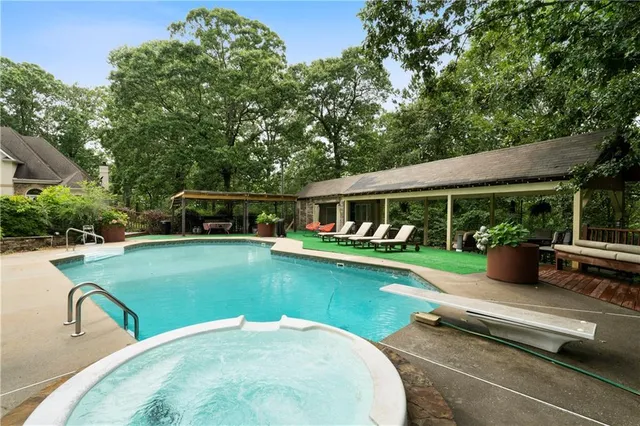 swimming pool view with a seating space