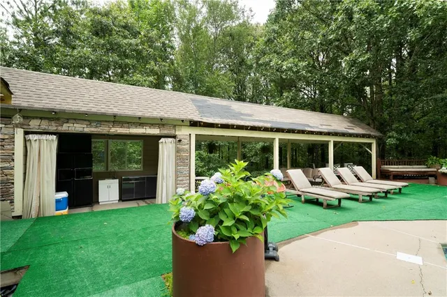 a view of a house with backyard sitting area and garden