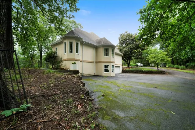 a white house that has a tree in front of it