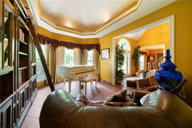 a living room with furniture fireplace and a large window