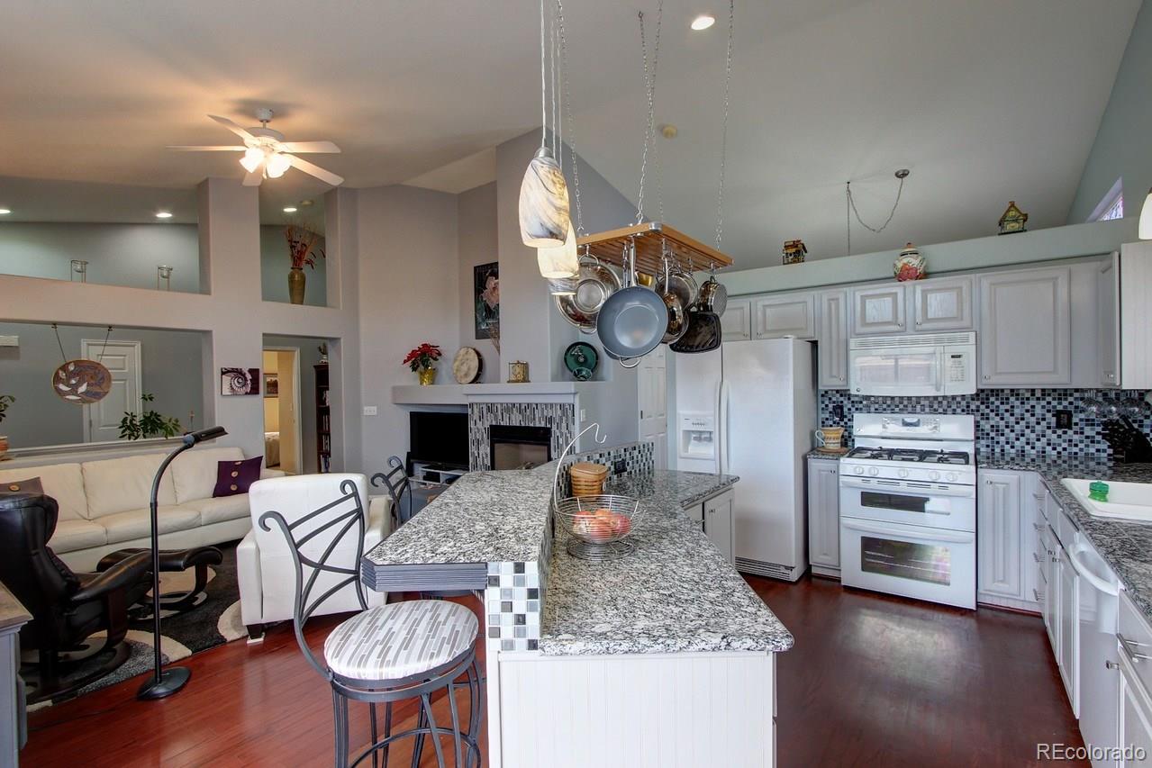 805 Nelson Park Drive Longmont, CO 80503 - Photo 12 of 33 a living room with fireplace furniture and a wooden floor