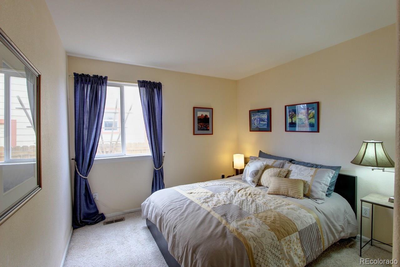 805 Nelson Park Drive Longmont, CO 80503 - Photo 16 of 33 a bedroom with a bed and a window