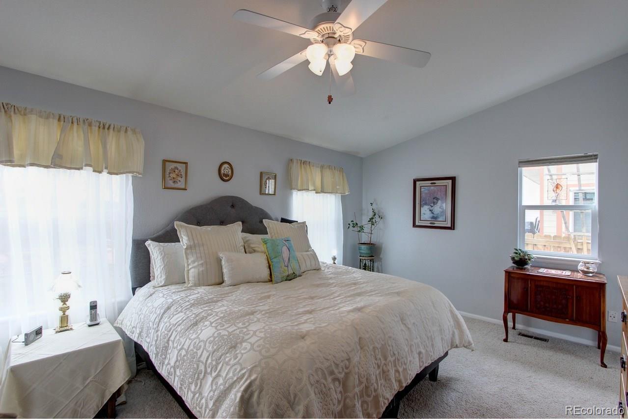 805 Nelson Park Drive Longmont, CO 80503 - Photo 17 of 33 a bedroom with a bed and a window
