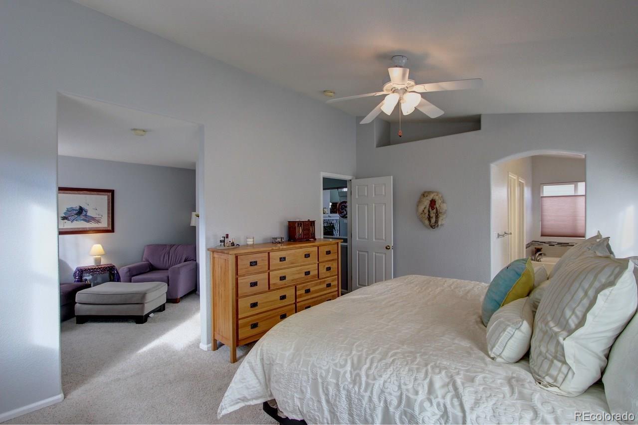 805 Nelson Park Drive Longmont, CO 80503 - Photo 18 of 33 a bedroom with a bed dresser and wooden floor