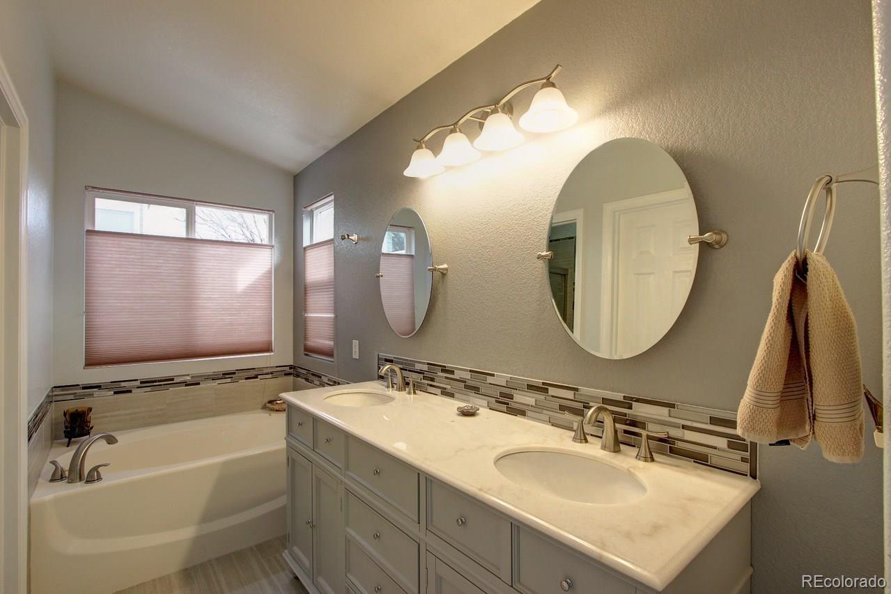 805 Nelson Park Drive Longmont, CO 80503 - Photo 20 of 33 a bathroom with a double vanity sink and a mirror