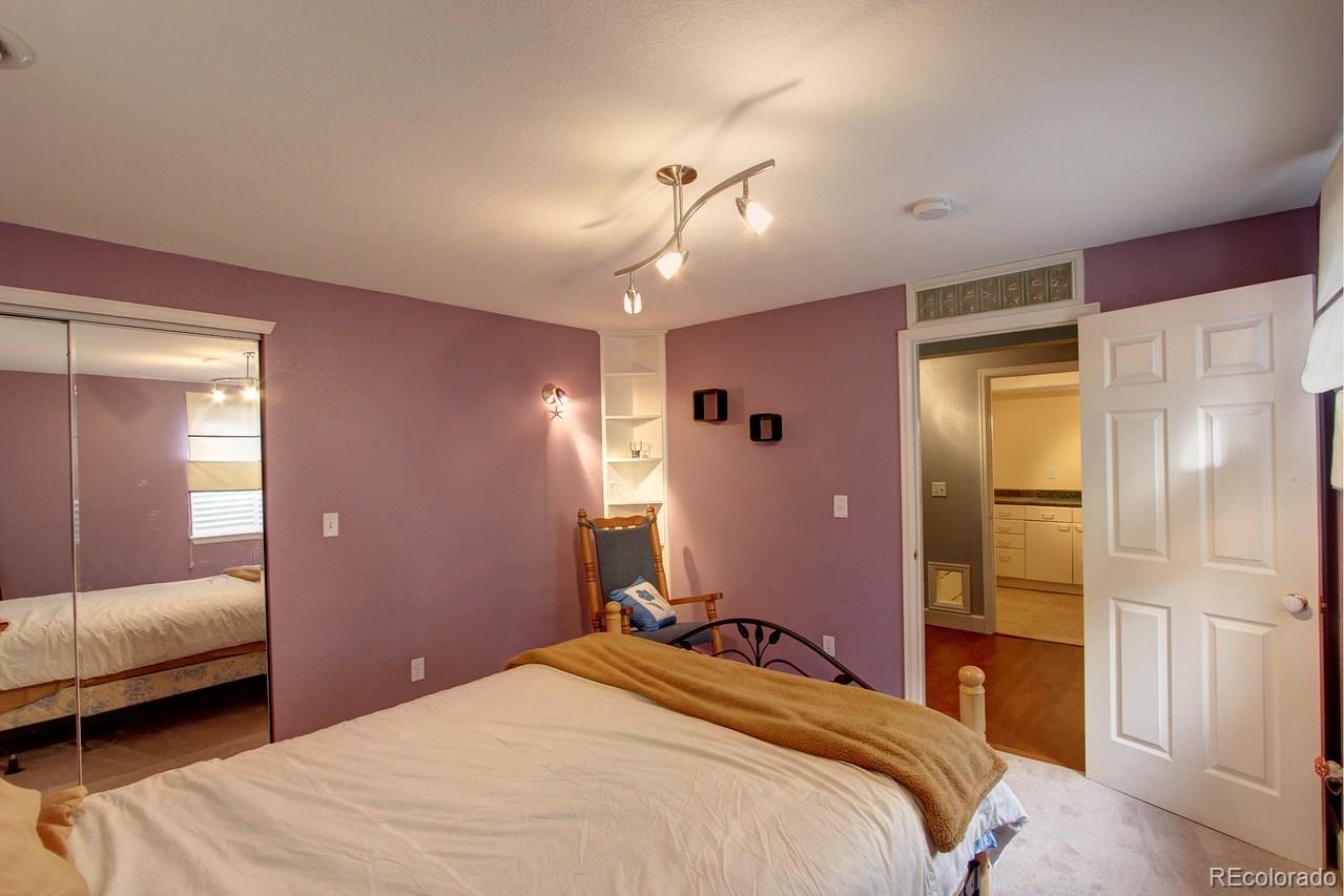 805 Nelson Park Drive Longmont, CO 80503 - Photo 24 of 33 a bedroom with a bed and a couch