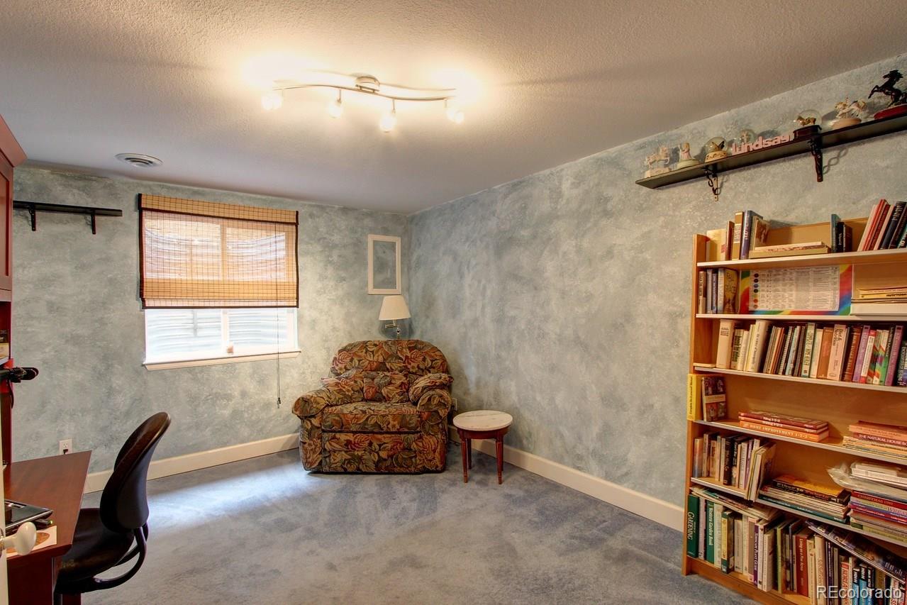 805 Nelson Park Drive Longmont, CO 80503 - Photo 27 of 33 a livingroom with a book shelf and a window