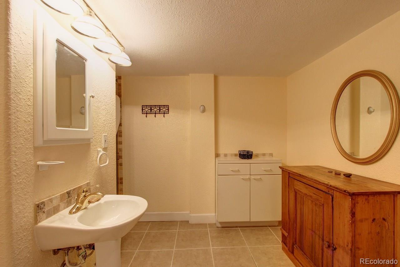 805 Nelson Park Drive Longmont, CO 80503 - Photo 28 of 33 a bathroom with a sink a toilet and shower