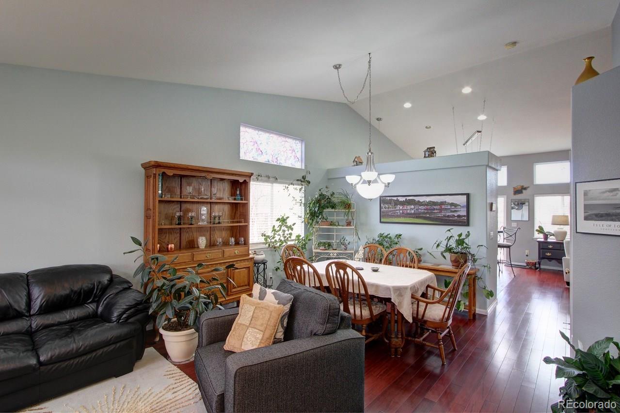 805 Nelson Park Drive Longmont, CO 80503 - Photo 3 of 33 a living room with furniture a fireplace and a flat screen tv