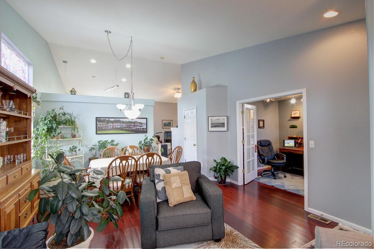 805 Nelson Park Drive Longmont, CO 80503 - Photo 4 of 33 a living room with furniture kitchen view and a chandelier