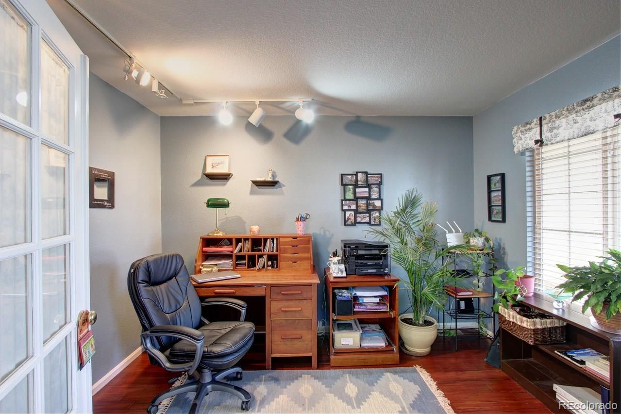 805 Nelson Park Drive Longmont, CO 80503 - Photo 5 of 33 a workspace with furniture window and wooden floor