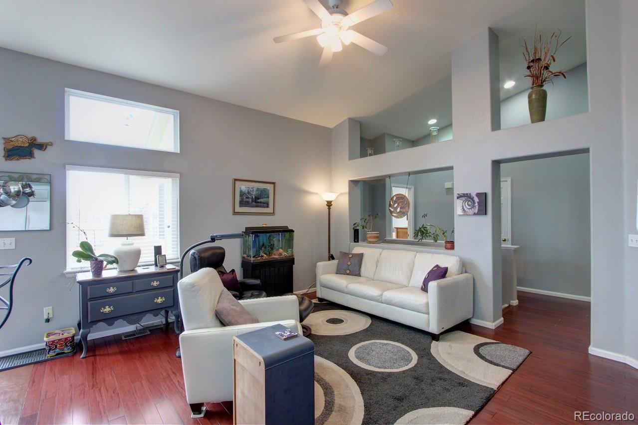 805 Nelson Park Drive Longmont, CO 80503 - Photo 10 of 33 a bedroom with furniture and wooden floor