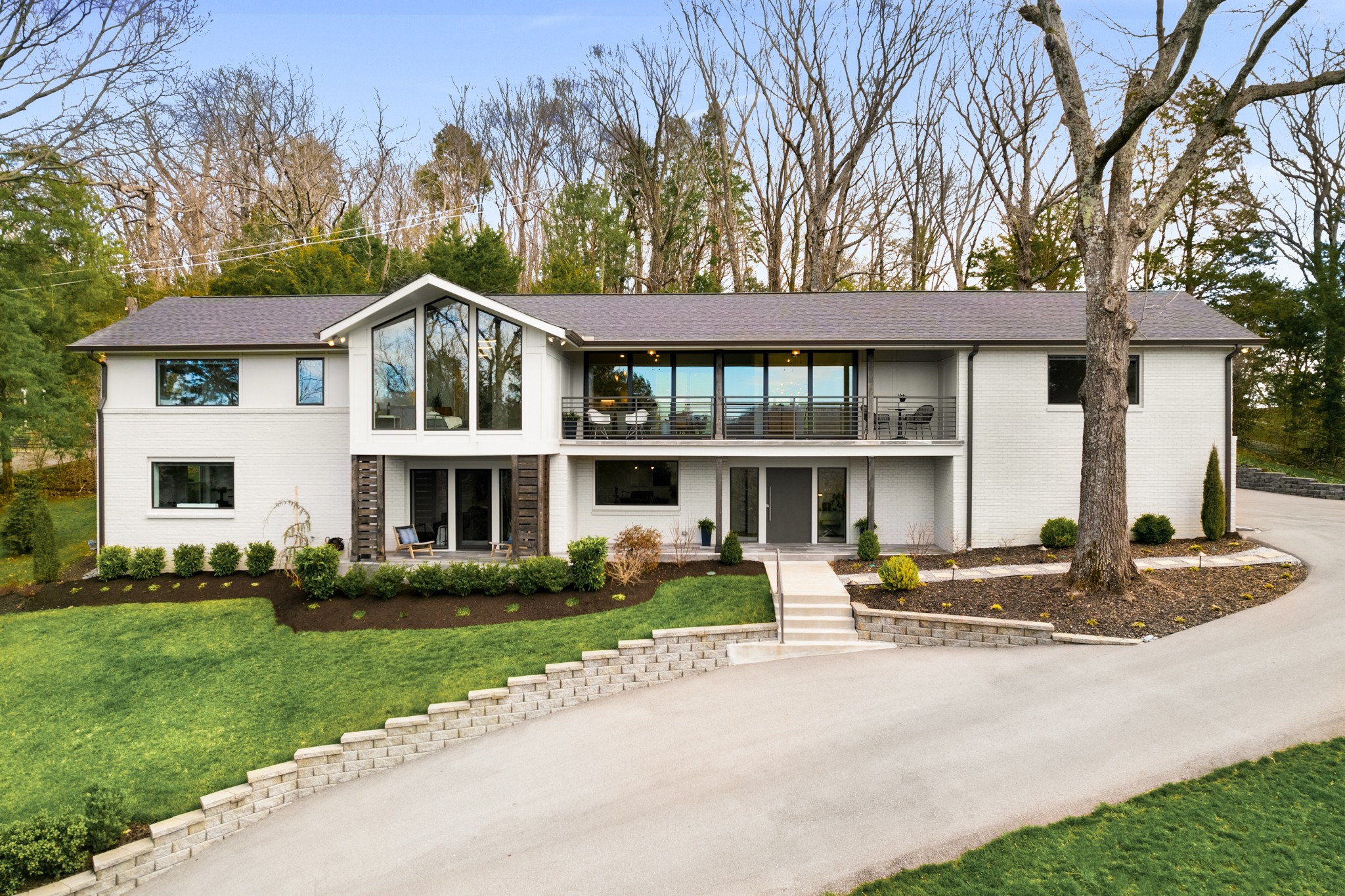 a front view of a house with a yard and trees