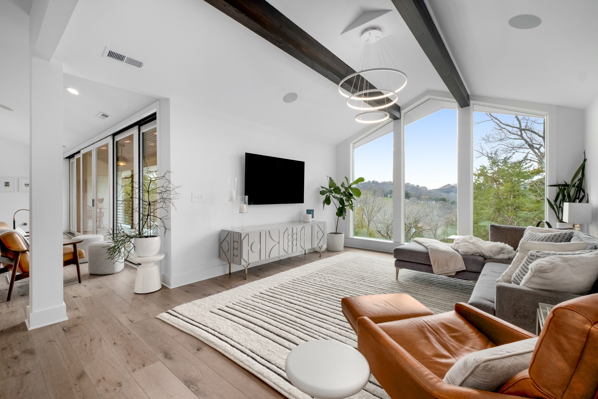 4628 Shys Hill Road Nashville, TN 37215 - Photo 21 of 42 a living room with furniture a flat screen tv and a large window