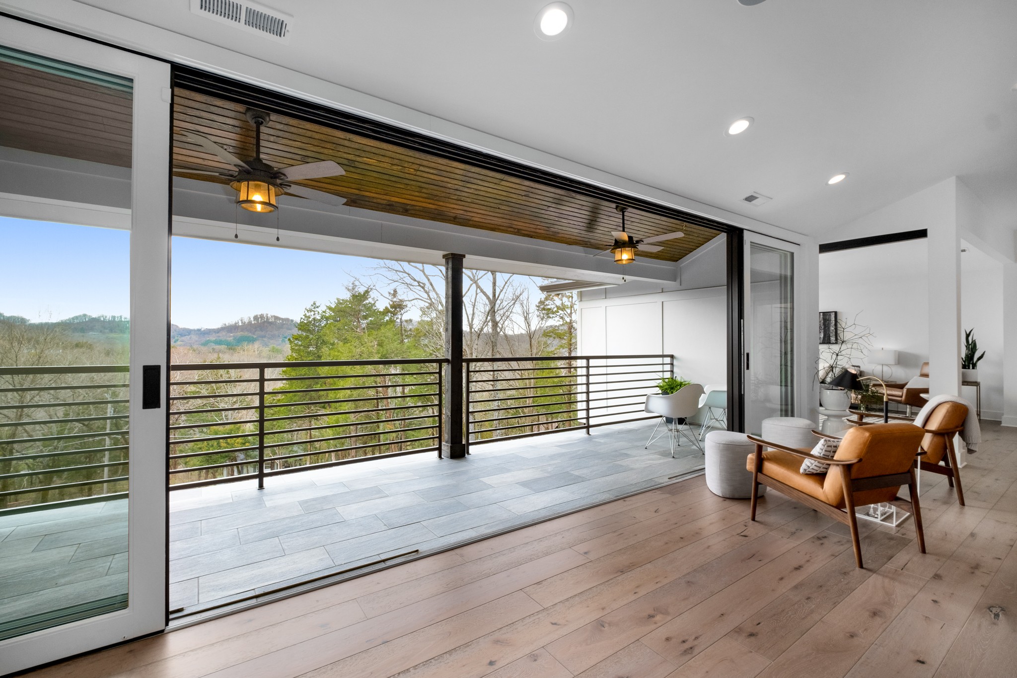 4628 Shys Hill Road Nashville, TN 37215 - Photo 24 of 42 an empty room with wooden floor and iron stairs