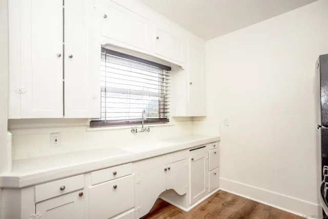 a kitchen with a sink cabinets and window