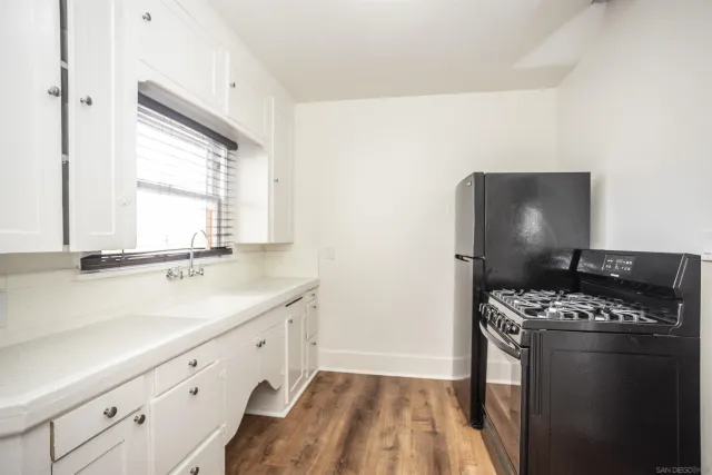 a kitchen with a sink stove and cabinets