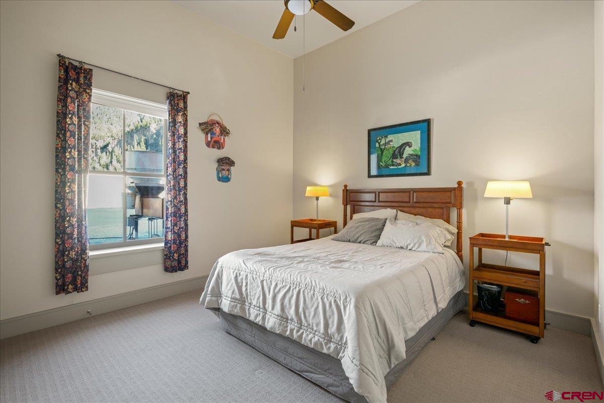 708 Main Street, Unit 3 Ouray, CO 81427 - Photo 13 of 28 a bedroom with a bed and a painting on the wall