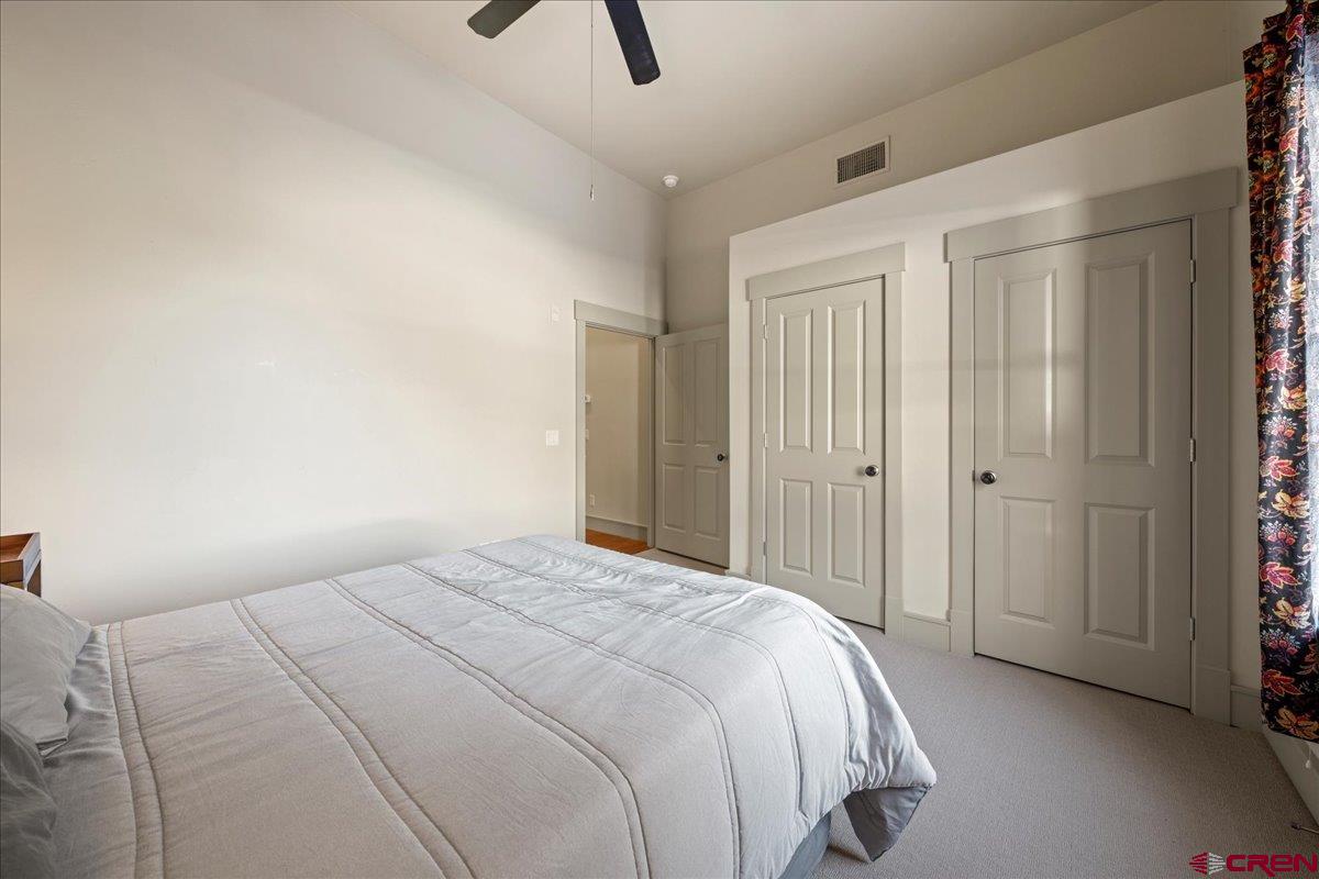 708 Main Street, Unit 3 Ouray, CO 81427 - Photo 14 of 28 a bedroom with a bed a walk in closet