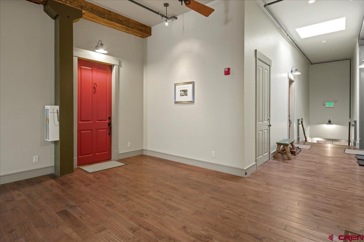 708 Main Street, Unit 3 Ouray, CO 81427 - Photo 4 of 28 an empty room with wooden floor and windows