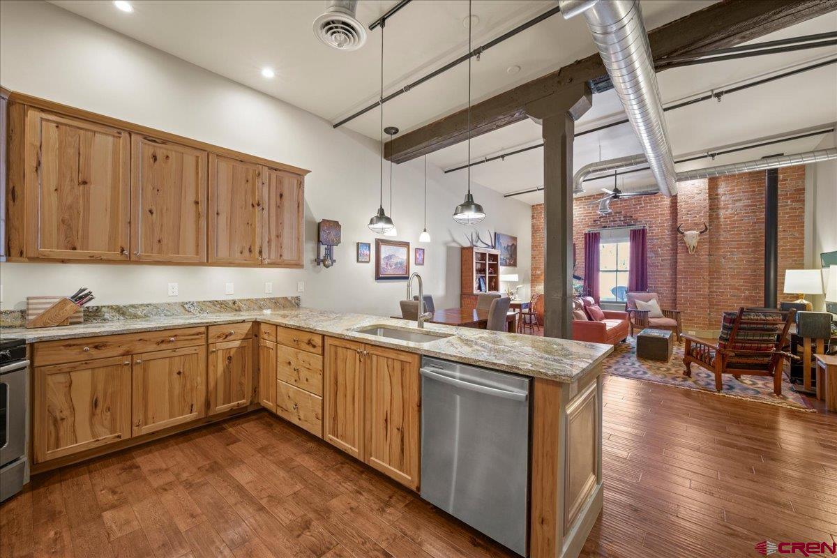 708 Main Street, Unit 3 Ouray, CO 81427 - Photo 5 of 28 a kitchen with stainless steel appliances granite countertop wooden cabinets a sink and dishwasher