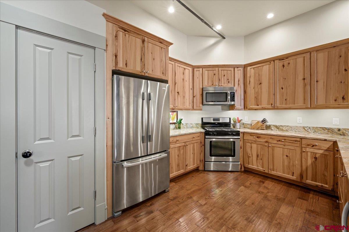 708 Main Street, Unit 3 Ouray, CO 81427 - Photo 6 of 28 a kitchen with granite countertop a refrigerator stove and microwave