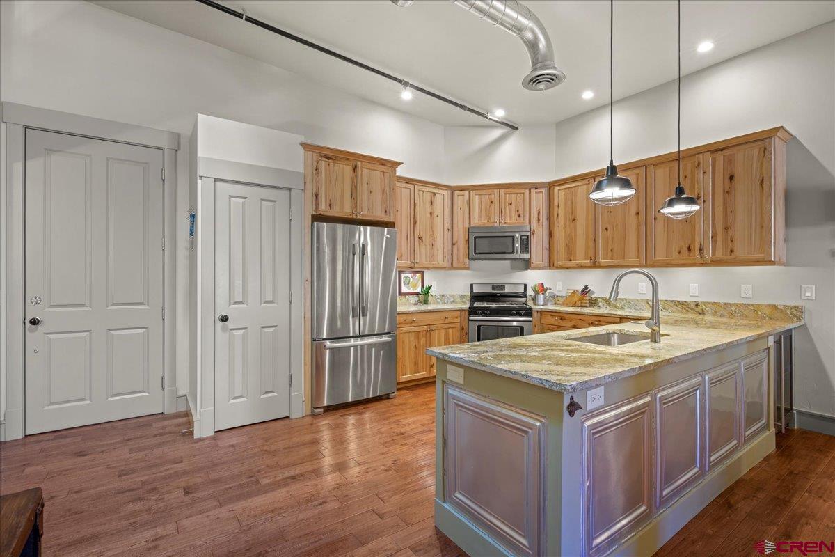 708 Main Street, Unit 3 Ouray, CO 81427 - Photo 7 of 28 a kitchen with a stove a refrigerator and a sink