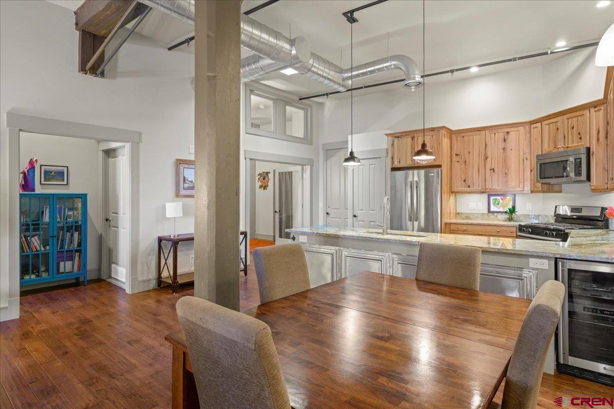 708 Main Street, Unit 3 Ouray, CO 81427 - Photo 8 of 28 a large kitchen with cabinets wooden floor and stainless steel appliances
