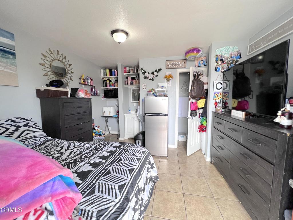 633 Meta Street Oxnard, CA 93030 - Photo 9 of 11 a bedroom with a bed and a flat screen tv