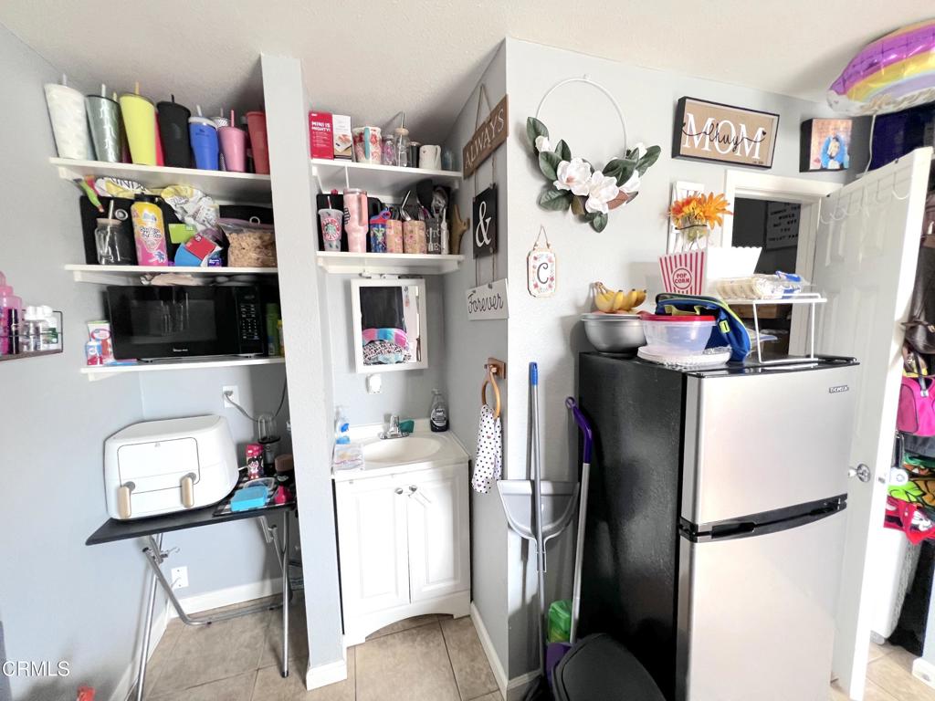 633 Meta Street Oxnard, CA 93030 - Photo 10 of 11 a room with furniture a rug and a book shelf