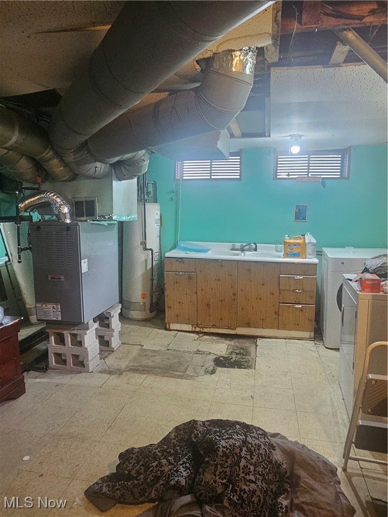 4407 Wyatt Road Cleveland, OH 44128 - Photo 25 of 25 Below grade area with visible vents, heating unit, light floors, separate washer and dryer, and water heater