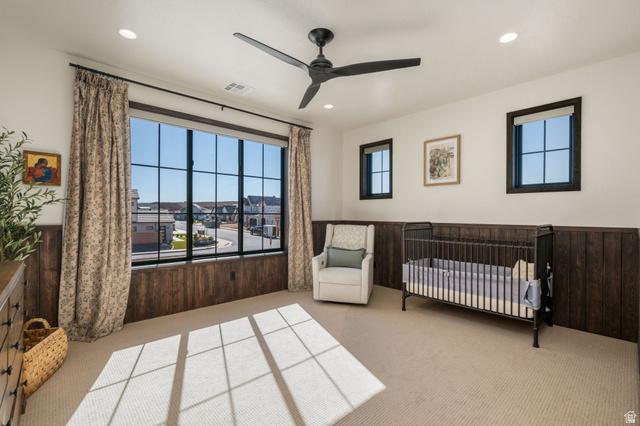 4871 South Homestead Way Washington, UT 84780 - Photo 73 of 151 Bedroom featuring a nursery area, light colored carpet, a ceiling fan, a wainscoted wall, and wooden walls