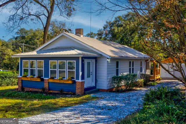 a view of a house with a yard and sitting area