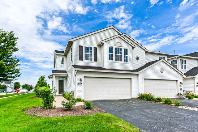 1079 Key Largo Drive Romeoville, IL 60446 - Photo 1 of 25 a front view of a house with a yard and garage