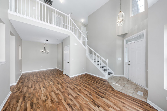 1079 Key Largo Drive Romeoville, IL 60446 - Photo 2 of 25 a view of an entryway wooden floor and staircase