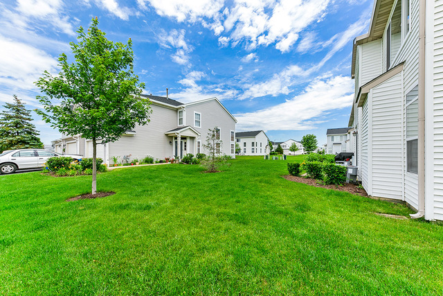 1079 Key Largo Drive Romeoville, IL 60446 - Photo 13 of 25 a view of an house with backyard space and garden