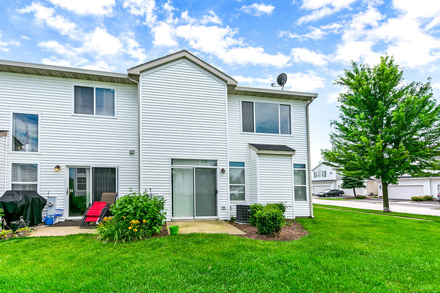 1079 Key Largo Drive Romeoville, IL 60446 - Photo 15 of 25 a front view of a house with a garden and plants