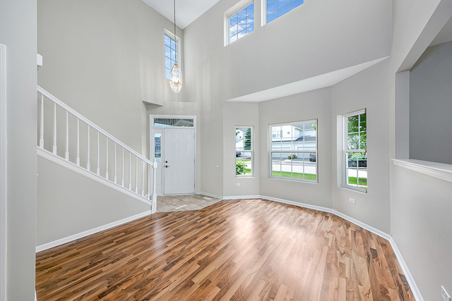 1079 Key Largo Drive Romeoville, IL 60446 - Photo 3 of 25 a view of an empty room with wooden floor and a window