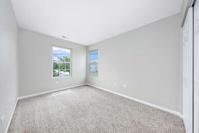 1079 Key Largo Drive Romeoville, IL 60446 - Photo 21 of 25 an empty room with windows