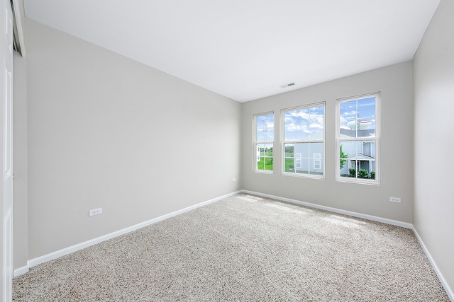 1079 Key Largo Drive Romeoville, IL 60446 - Photo 22 of 25 an empty room with windows