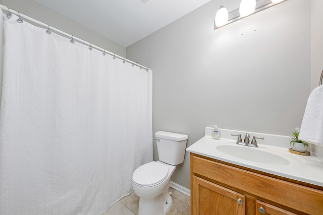 1079 Key Largo Drive Romeoville, IL 60446 - Photo 23 of 25 a bathroom with a sink a toilet and a mirror