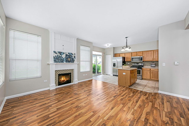 1079 Key Largo Drive Romeoville, IL 60446 - Photo 4 of 25 a view of kitchen and empty room with wooden floor