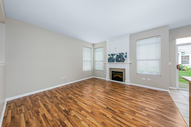 1079 Key Largo Drive Romeoville, IL 60446 - Photo 5 of 25 a view of empty room with fireplace and windows