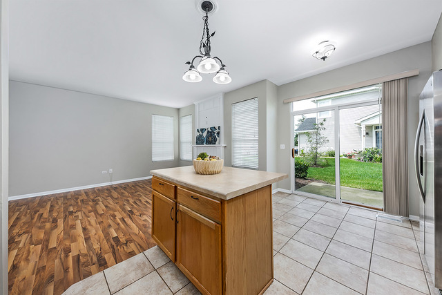 1079 Key Largo Drive Romeoville, IL 60446 - Photo 6 of 25 a view of a kitchen with a sink and chandelier