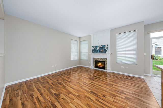 1079 Key Largo Drive Romeoville, IL 60446 - Photo 9 of 25 a view of a livingroom with a fireplace window and wooden floor