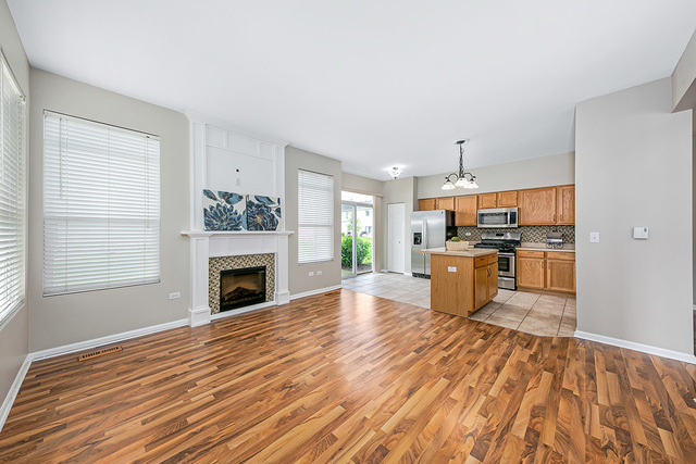 1079 Key Largo Drive Romeoville, IL 60446 - Photo 10 of 25 a view of kitchen with kitchen island wooden floor and refrigerator