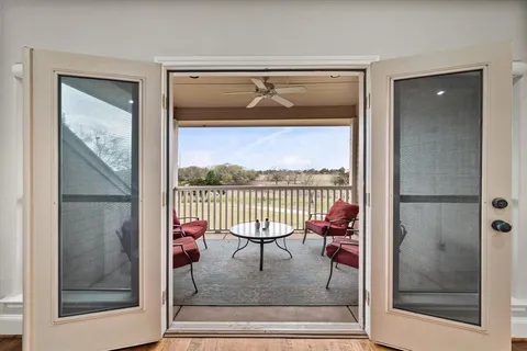a balcony with table and chairs